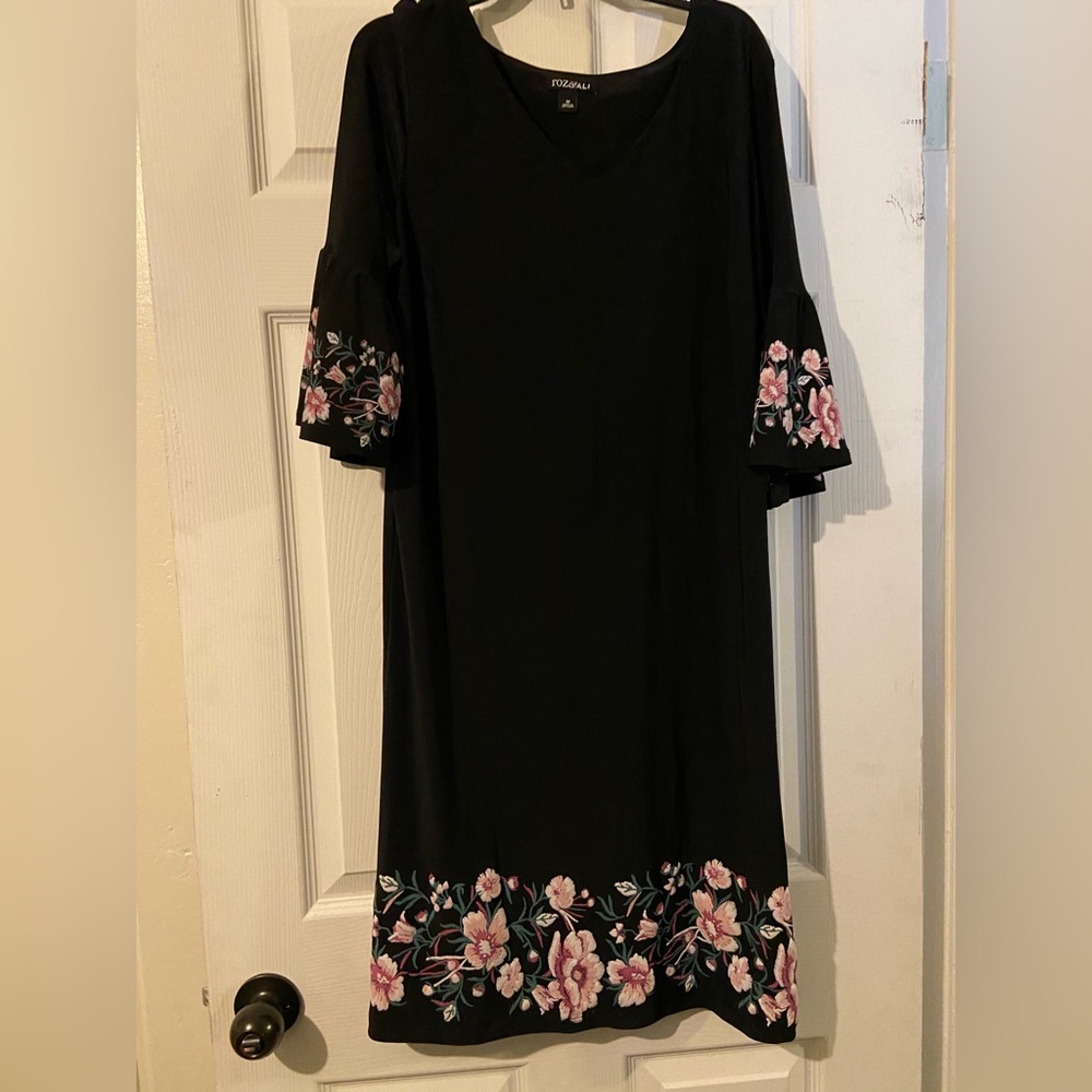 New black dress with floral trim.